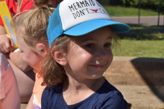 Girl Smiling in Trucker Hat at Dream Big | Hilltop Denver and Greenwood Village