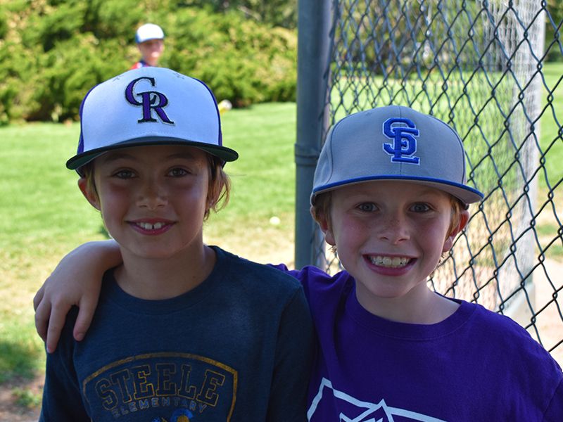 Two kids in Baseball Field at Dream Big Summer Day Camp | Hilltop Denver and Greenwood Village